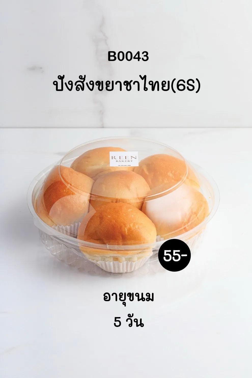 ภาพขนมปังสังขยาชาไทย 6 ชิ้น บรรจุในกล่องพลาสติกใสทรงกลม แต่ละชิ้นวางในถ้วยกระดาษสีขาว มีสติกเกอร์ REEN BAKERY ติดอยู่บนฝากล่อง พร้อมป้ายราคา